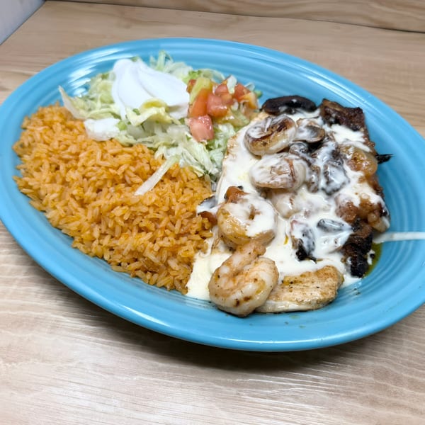 Don Tequila's Mexican dish with rice, lettuce, tomato, sour cream, and shrimp in a creamy sauce.